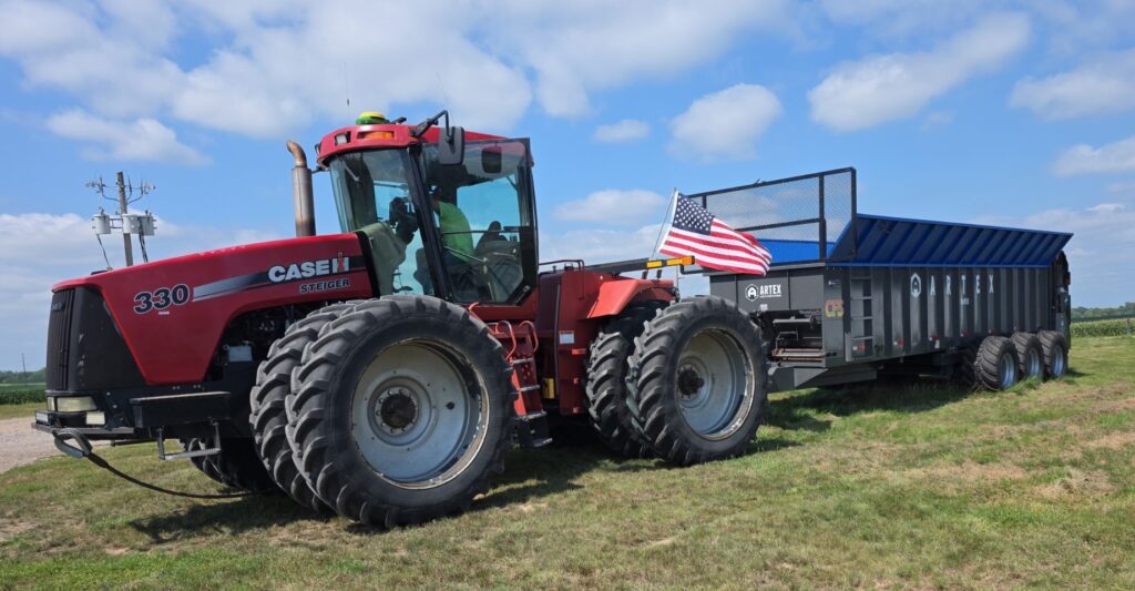 Case 330 tractor pulling an Artex manure spreader for custom manure spreading